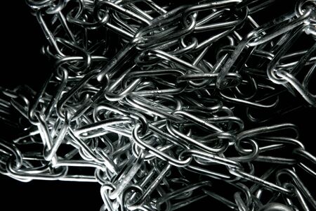 Steel chain mess texture over black backgroundの写真素材