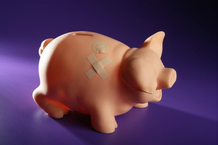 Hurted savings piggy bank, credit financial crisis metaphorの写真素材