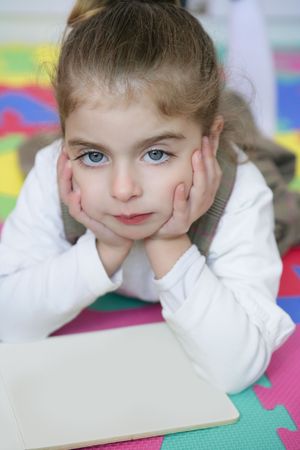 Beautiful preschooler little girl student learning with homework book