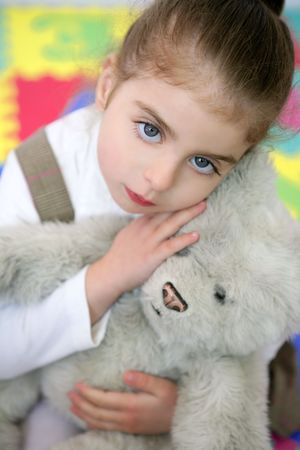 Beautiful preschooler student little girl hug her teddy bearの写真素材