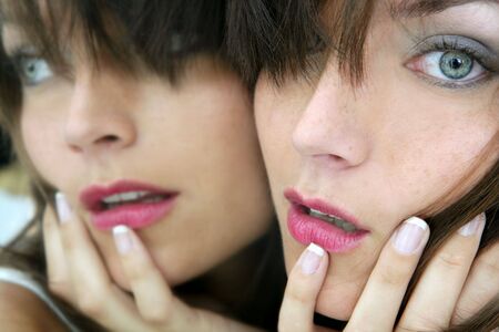 Beautiful blue eyes woman on the mirror as a twins portrait