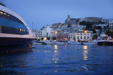 Ibiza island harbor and city under night light in Mediterranean seaの写真素材