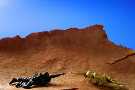 War metaphor, toy little soldiers fighting on wooden mountainの写真素材