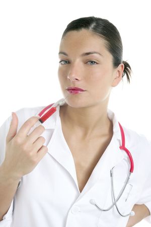 Doctor woman with red syringe and needle in her lips over white backgroundの写真素材