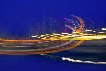 Abstract night blurry colorful lighs in movemet over blue backgroundの写真素材