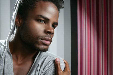 African american man with gray hood over wallpaper backgroundの写真素材