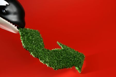 Earth conservation metaphor, orca whale with recycle green sign in jaws  の写真素材
