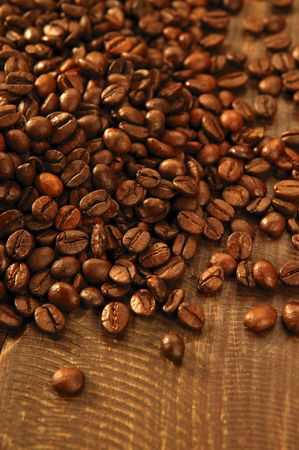 Toasted coffe beans texture under golden lightの写真素材