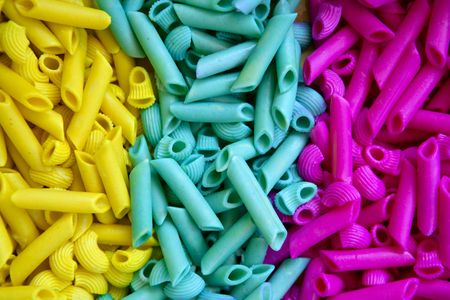 Colorful pasta food in three colors, yellow, blue and pinkの写真素材