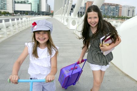 Little girls going to school with bags, books and student stuffの写真素材