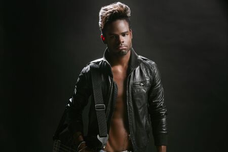 Afro american rock star musician with leather jacket and bass guitarの写真素材