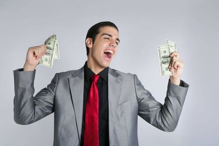 Businessman young with dollar notes suit and tie on gray backgroundの写真素材