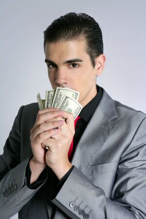 Businessman young with dollar notes suit and tie on gray backgroundの写真素材