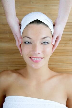 Head massage over bamboo, beautiful blue eyes womanの写真素材