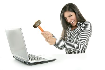 Angry brunette businesswoman with hammer against screenの写真素材