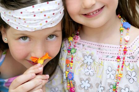 closeup portrait of two little happy beautiful girl sistersの写真素材