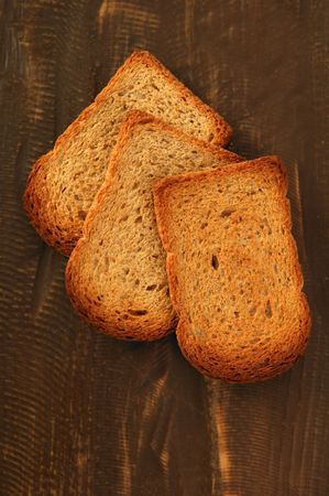 Toasted bread slices over old dark wood backgroundの写真素材