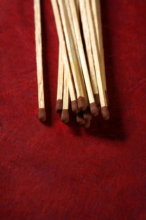 Arrangement of wooden light matches over red backgroundの写真素材