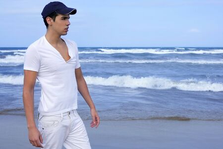Handsome young man on the blue ocean beach summer seaの写真素材