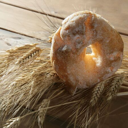 Delicious roll bakery with sugar and wheat ear spikesの写真素材