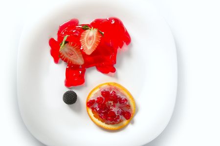Modern dessert plate with strawberries, berries, jelly and orangeの写真素材