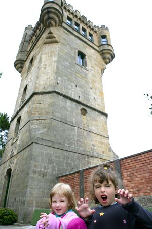 Adorable couple sisters scare gesture under Igueldo Castle in San Sebastianの写真素材