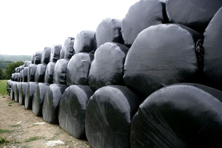 Black plastic wrap cover for wheat cereal bales outdoorの写真素材