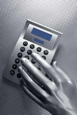 business futuristic silver hand metaphor on calculator keyboardの写真素材