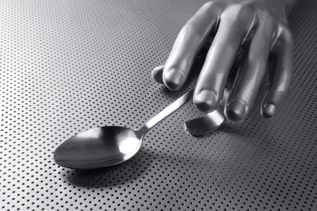 gray silver hand and spoon futuristic food modern metaphorの写真素材
