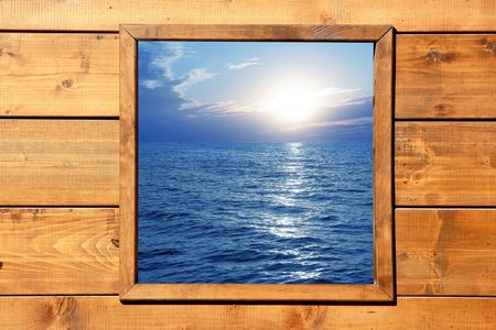 Window seascape view from wooden frame roomの写真素材