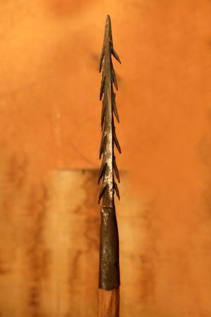 African lance weapon iron arrowhead in orange background   の写真素材