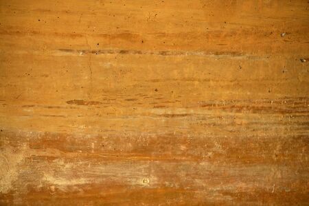 Grunge orange wall texture background in golden colors