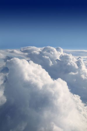 Blue sky view from aircraft airplane and white clouds, textureの写真素材
