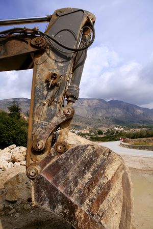 Backhoe bulldozer working hard with stones の写真素材
