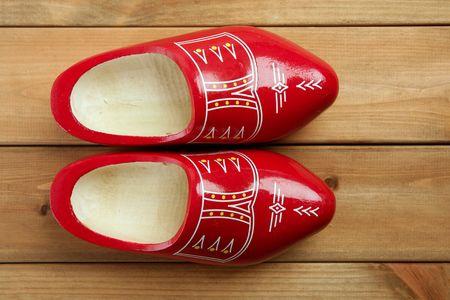 Dutch Holland red wooden shoes on wood backgroundの写真素材