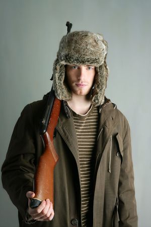 Hunter man fur winter hat holding rifle gun brown autumn coat