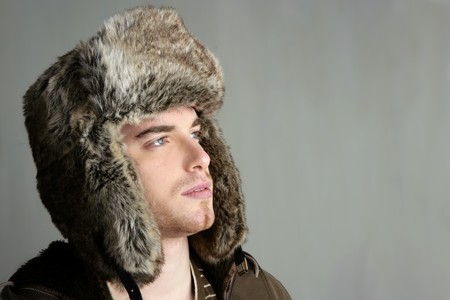 winter fur hat portrait of fashion young handsome manの写真素材