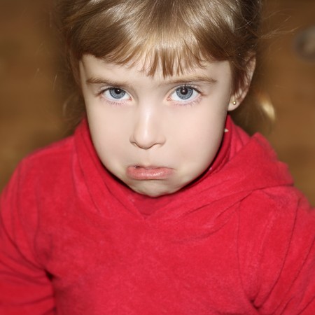 crying weeping gesture face little blond girl face portrait  の写真素材