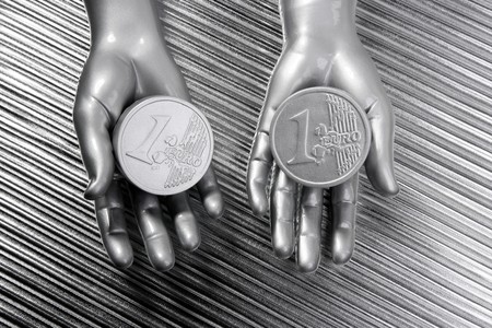 two silver euro coins in futuristic robot gray metallic hands bank metaphorの写真素材