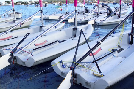 Laser little sailboats row in Formentera Balearic islandsの写真素材