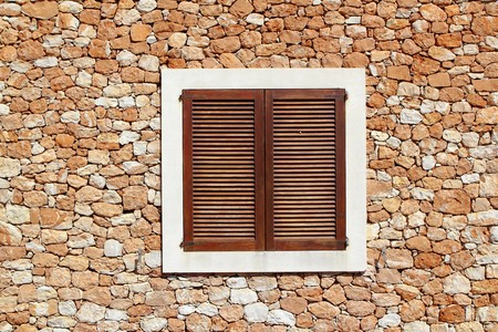 brown wooden window in masonry wall balearic islandsの写真素材