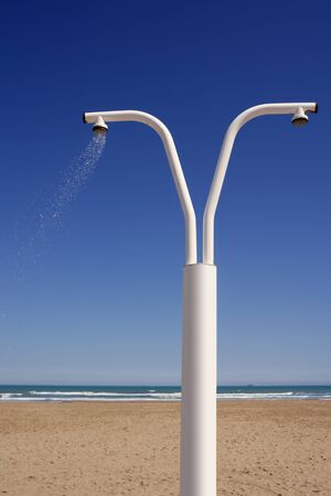 Beach shower over blue sky sand sea summer vacationの写真素材