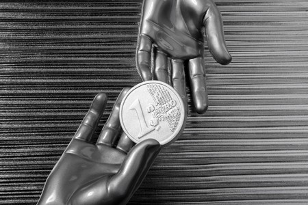 silver euro coins in futuristic robot gray metallic hands bank metaphor