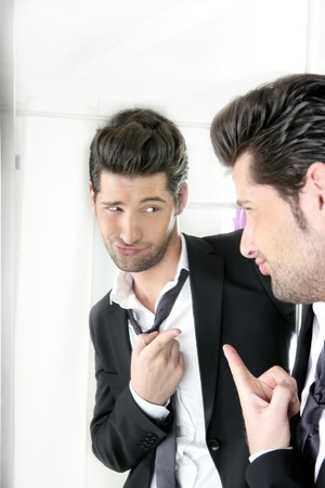 Handsome suit proud young man humor funny gesturing in a mirror の写真素材