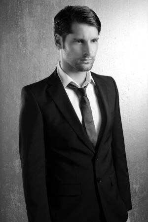 Classic elegant black and white suit handsome man portraitの写真素材