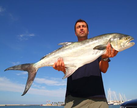 Fisherman holding catch Garrick Lichia Amia Leerfish Leervis fishJack