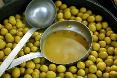 olives in pickling brine pattern background texture in marketの写真素材