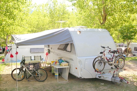 Camping camper caravan trees park with bicycles