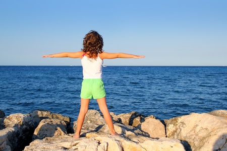 open arms girl looking blue ocean sea feeling freedom in vacationの写真素材