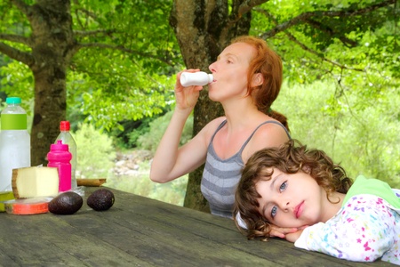Mother daughter picnic outdoor park relaxed girlの写真素材